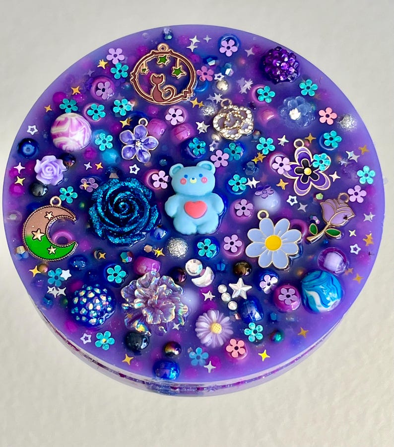 Celestial Amethyst Picky Pad for Skin Picking & Stress Relief Close-Up of Bead-Filled Sensory Fidget Pad with Moon & Star Charms Silicone Picking Pad with Purple Galaxy Theme & Glitter Details Anxiety & Nail Biting Relief Picky Pad with Beads & Cosmic Accents Fidget Pick Pad for ADHD, OCD & Astrology Lovers