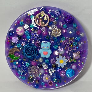 Celestial Amethyst Picky Pad for Skin Picking & Stress Relief Close-Up of Bead-Filled Sensory Fidget Pad with Moon & Star Charms Silicone Picking Pad with Purple Galaxy Theme & Glitter Details Anxiety & Nail Biting Relief Picky Pad with Beads & Cosmic Accents Fidget Pick Pad for ADHD, OCD & Astrology Lovers