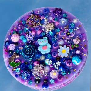 Celestial Amethyst Picky Pad for Skin Picking & Stress Relief Close-Up of Bead-Filled Sensory Fidget Pad with Moon & Star Charms Silicone Picking Pad with Purple Galaxy Theme & Glitter Details Anxiety & Nail Biting Relief Picky Pad with Beads & Cosmic Accents Fidget Pick Pad for ADHD, OCD & Astrology Lovers