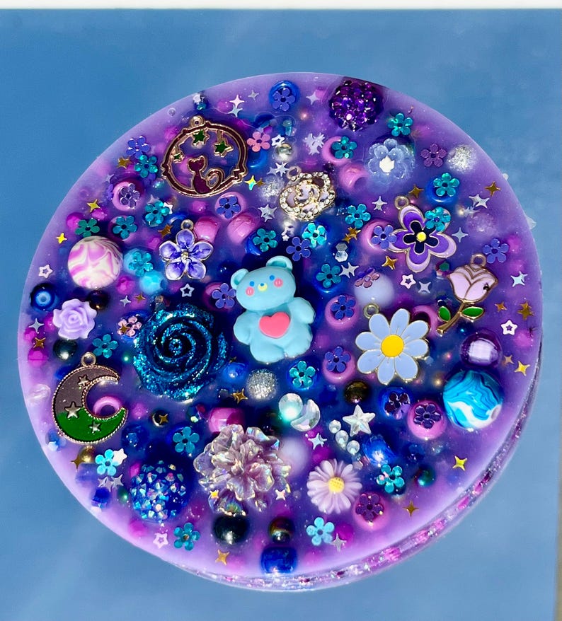 Celestial Amethyst Picky Pad for Skin Picking & Stress Relief Close-Up of Bead-Filled Sensory Fidget Pad with Moon & Star Charms Silicone Picking Pad with Purple Galaxy Theme & Glitter Details Anxiety & Nail Biting Relief Picky Pad with Beads & Cosmic Accents Fidget Pick Pad for ADHD, OCD & Astrology Lovers