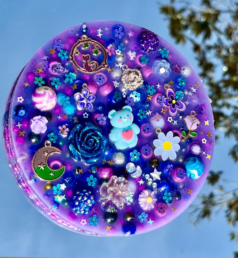 Celestial Amethyst Picky Pad for Skin Picking & Stress Relief Close-Up of Bead-Filled Sensory Fidget Pad with Moon & Star Charms Silicone Picking Pad with Purple Galaxy Theme & Glitter Details Anxiety & Nail Biting Relief Picky Pad with Beads & Cosmic Accents Fidget Pick Pad for ADHD, OCD & Astrology Lovers