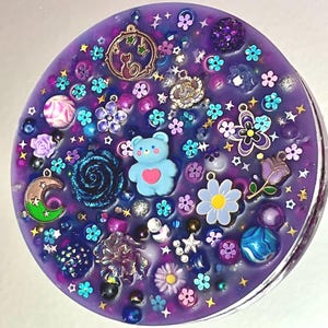 Celestial Amethyst Picky Pad for Skin Picking & Stress Relief Close-Up of Bead-Filled Sensory Fidget Pad with Moon & Star Charms Silicone Picking Pad with Purple Galaxy Theme & Glitter Details Anxiety & Nail Biting Relief Picky Pad with Beads & Cosmic Accents Fidget Pick Pad for ADHD, OCD & Astrology Lovers