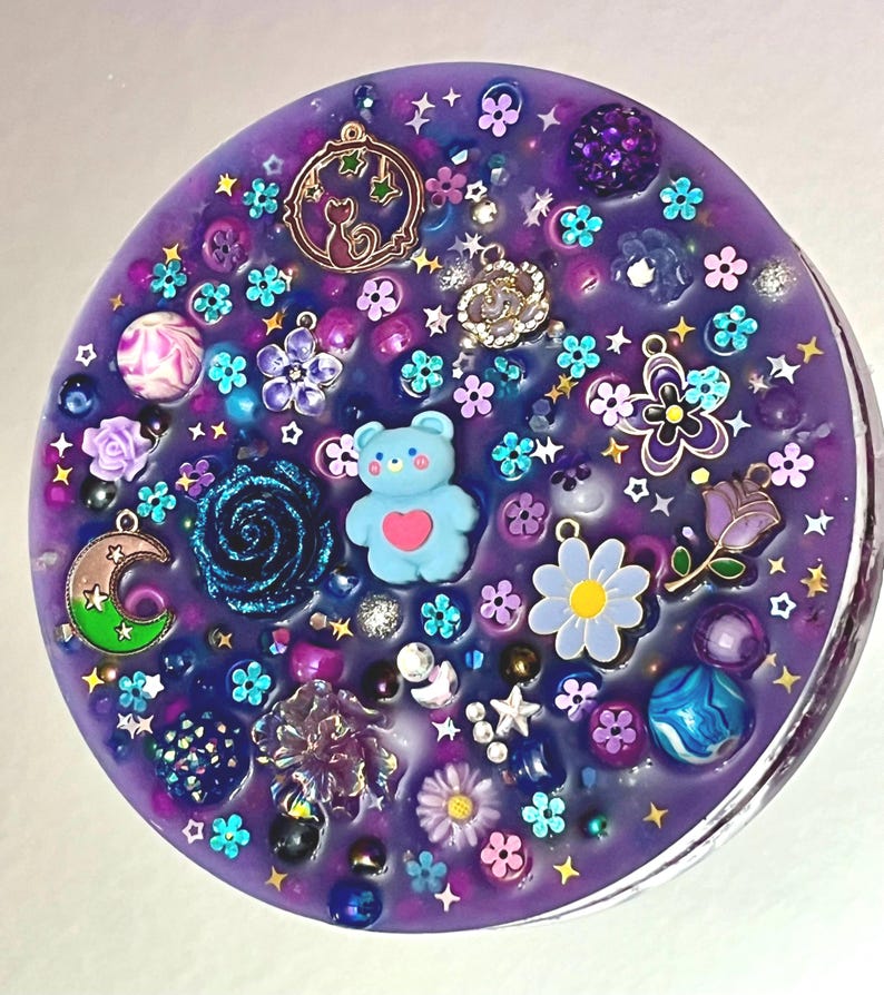 Celestial Amethyst Picky Pad for Skin Picking & Stress Relief Close-Up of Bead-Filled Sensory Fidget Pad with Moon & Star Charms Silicone Picking Pad with Purple Galaxy Theme & Glitter Details Anxiety & Nail Biting Relief Picky Pad with Beads & Cosmic Accents Fidget Pick Pad for ADHD, OCD & Astrology Lovers