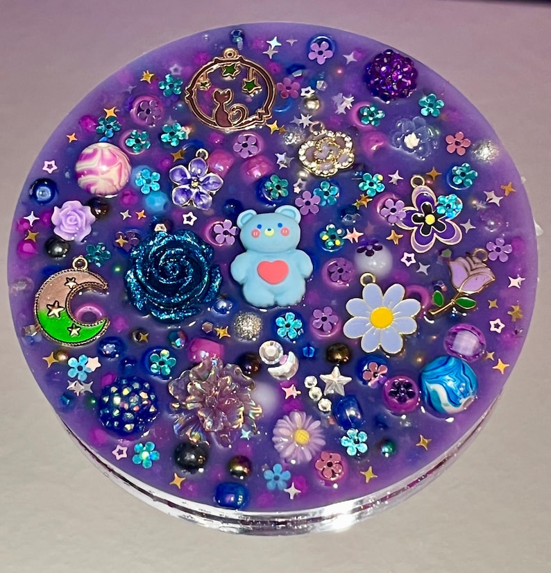 Celestial Amethyst Picky Pad for Skin Picking & Stress Relief Close-Up of Bead-Filled Sensory Fidget Pad with Moon & Star Charms Silicone Picking Pad with Purple Galaxy Theme & Glitter Details Anxiety & Nail Biting Relief Picky Pad with Beads & Cosmic Accents Fidget Pick Pad for ADHD, OCD & Astrology Lovers