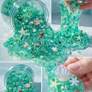 May include: A jar of teal-colored slime with glitter, seashells, and starfish. The slime is spilling out of the jar, creating a textured, flowing effect. The text "PickyPadsTherapy" is at the top. The slime is decorated with small corked bottles.