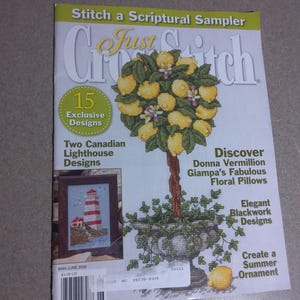 May include: A magazine cover titled "Just Cross Stitch" features a cross-stitch design of a lemon tree. The cover includes text about exclusive designs, lighthouse designs, floral pillows, and blackwork designs.