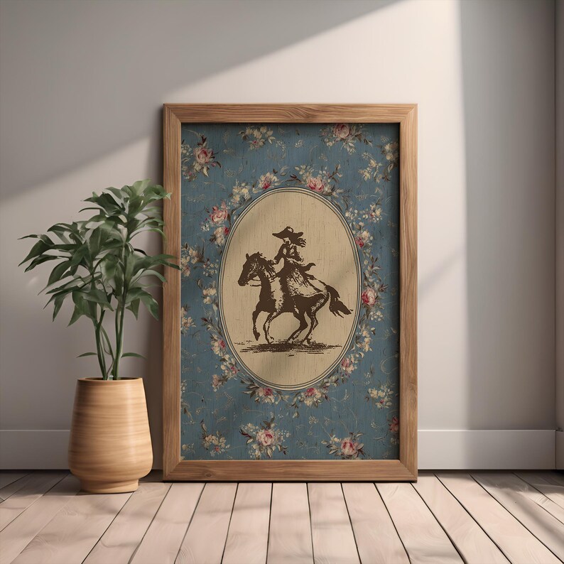 May include: A framed print featuring a sepia-toned illustration of a person riding a horse. The illustration is set within an oval frame against a blue floral background. The wooden frame adds a rustic touch to the artwork.