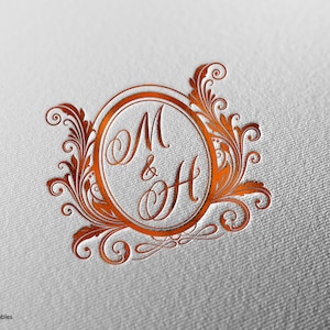 May include: A copper-colored monogram with the letters M and H intertwined inside a decorative oval frame. The letters are joined by an ampersand symbol. The frame is surrounded by ornate floral designs.