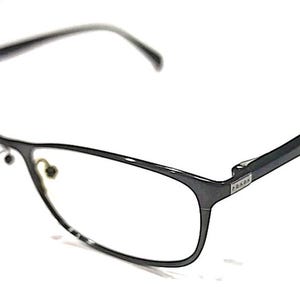 May include: Dark gray rectangular eyeglasses with clear lenses. The frames are a sleek, modern design with a subtle Prada logo on the temple. The glasses are set against a white background.