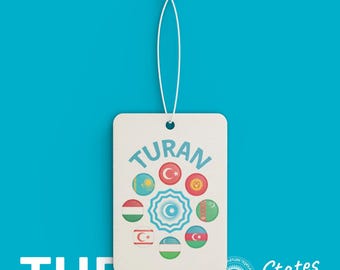 May include: A white rectangular tag with the word "TURAN" in blue, featuring a circular design with various flags. The tag is suspended by a white string against a bright blue background. The words "States Shop" are also visible.