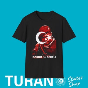 May include: Black t-shirt with a red and white image of a soldier wearing a red beret and holding a gun. The image includes a crescent moon and star. The text "Bordo Bereli" is printed below the image.