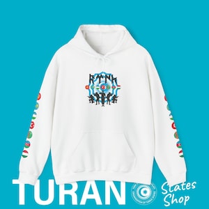May include: White hoodie with a blue and white circle design featuring a star and crescent moon, surrounded by flags of various Turkic states. The text "TURAN" is printed on the bottom of the hoodie. The sleeves feature a pattern of small flags of Turkic states.