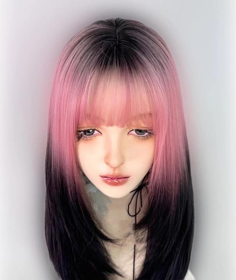 May include: A black and pink ombre wig with bangs. The wig is styled in a straight, shoulder-length cut.