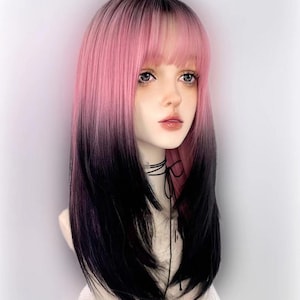 May include: A long, straight wig with pink and black ombre hair. The wig has bangs and is styled in a layered cut.