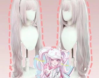 May include: Two light purple wigs with long pigtails are displayed on mannequin heads. The wigs have bangs and are set against a pink background. An anime-style illustration of a girl with pink hair and a matching outfit is in the foreground.