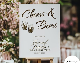 May include: A white sign on a wooden easel with the words "Cheers & Beers" in brown script. Below, it reads "Welcome to Vince and Natasha's Engagement Party 04 Sept 2025." Two beer mugs are illustrated above the text.