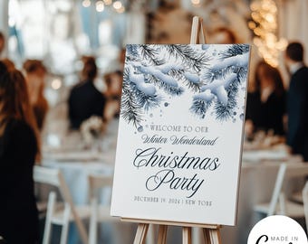 May include: A white sign on a wooden easel, with the text "Welcome to Our Winter Wonderland Christmas Party" in elegant script. The top of the sign features a snowy pine branch design. The date "December 19, 2024 | New York" is also displayed.