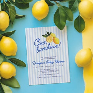 May include: A blue and white striped baby shower invitation with the text "Ciao bambino!" and lemons. The invitation includes the date, time, and location of the event. It also requests an RSVP with a phone number and asks guests to wear their best Italian summer outfit.