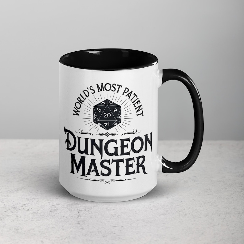 May include: White ceramic mug with a black rim and handle. The mug features a black and white graphic of a twenty-sided die with the text "World's Most Patient Dungeon Master".