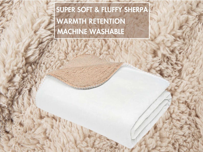 May include: A folded white blanket with a tan sherpa lining. The blanket is on a fluffy, tan surface. Text on the image reads: "SUPER SOFT & FLUFFY SHERPA, WARMTH RETENTION, MACHINE WASHABLE."