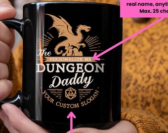 May include: A black ceramic mug featuring a gold-toned graphic of a dragon above the text "The Dungeon Daddy" and a twenty-sided die icon. The design includes placeholders for custom text, specifically "PERSONALIZE ME" and "YOUR CUSTOM SLOGAN."