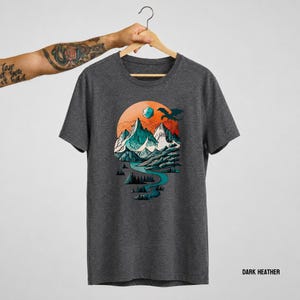 Dark Heather grey unisex t-shirt with the DnD adventure mountain design on a hanger — vintage circular landscape print in teal, orange, and white tones, labeled Dark Heather