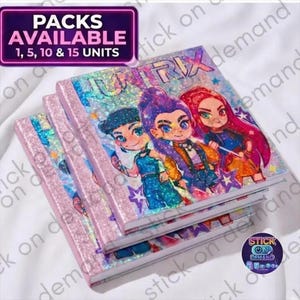 May include: Three notebooks stacked. The covers display a colourful illustration of three cartoon characters with the word "HUNTRIX" above. The notebooks have pink glitter edges. A sign in the top left corner reads "PACKS AVAILABLE 1, 5, 10 & 15 UNITS".