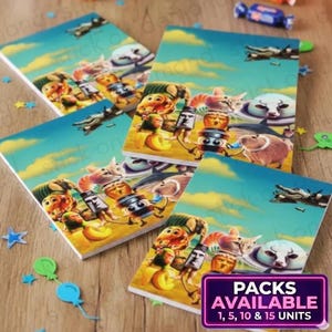 May include: Four square notebooks with a colorful cartoon illustration of various characters on a beach with a blue sky background. The notebooks have a white border. The text "PACKS AVAILABLE 1, 5, 10 & 15 UNITS" is in a purple box.