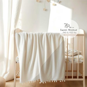 May include: A white crib with a white and gray checkered blanket draped over the side. The blanket has white pom-poms along the bottom edge. The crib is made of wood and has a white mattress. The crib is in a room with white walls and a white curtain. The text "Sweet Mockup PNG & PSD file" is visible in the image.