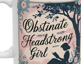 May include: White ceramic mug with a design featuring the words "Obstinate Headstrong Girl". The design includes a silhouette of a woman reading under a tree, surrounded by flowers. A perfect gift for book lovers.