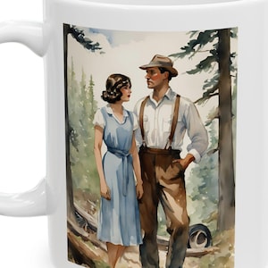 May include: White ceramic mug featuring a watercolor illustration of a couple in vintage attire standing in a forest. The man wears a hat, suspenders, and brown pants, while the woman is in a blue dress. The background shows trees.