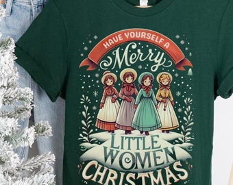 May include: A dark green t-shirt with the text "Have Yourself a Merry Little Women Christmas" and an illustration of four women in dresses. The shirt is hanging on a wooden hanger next to a pair of blue jeans and a small Christmas tree.