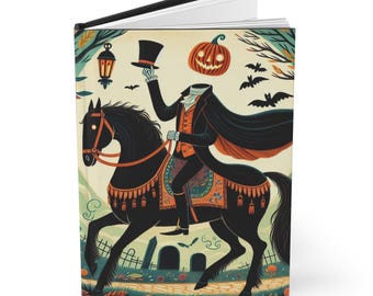 May include: Hardcover journal featuring a Halloween-themed illustration. The image depicts a headless figure on horseback, holding a top hat, with a jack-o'-lantern head. The horse is black, and the background includes bats, trees, and a graveyard.