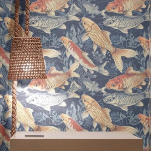 May include: Bedroom interior with a navy blue wallpaper featuring a pattern of orange and silver koi fish. A light brown woven headboard and a beige nightstand with three drawers and brown handles are visible. A woven lamp hangs from the ceiling.
