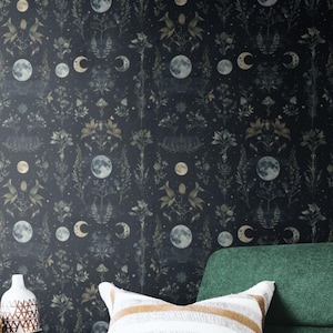 May include: A dark green upholstered armchair with a wooden frame and a white and brown striped throw pillow. Beside the chair are two small round wooden tables with black metal legs, holding a black bottle, a white patterned vase, and a bowl.