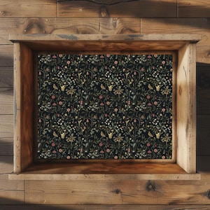 Op de afbeelding: Een rechthoekige houten kist met een open bovenkant, voorzien van een plat binnenpaneel versierd met een dicht botanisch patroon op een zwarte achtergrond, met kleine gele vogels, roze bloemen en groen gebladerte in een herhalend ontwerp.