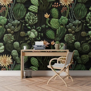 May include: A home office workspace with a desk, chair, and a typewriter. The wall is covered in a dark green and brown wallpaper with a cactus pattern.