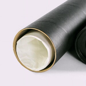 May include: A partially open black cardboard tube with a tan interior and a white paper lining. The tube is designed to protect rolled artwork or documents. The end of the tube is visible, revealing the contents.