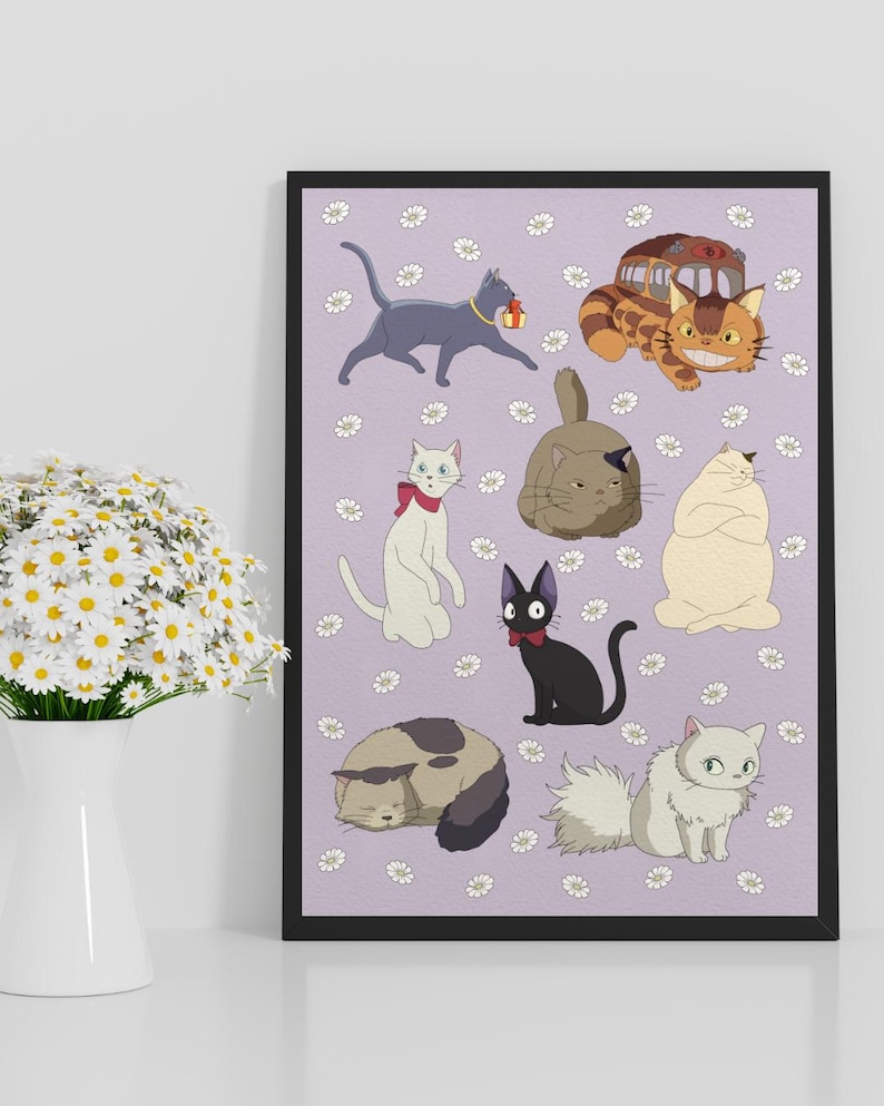 May include: A framed print featuring cartoon cats in various poses, set against a lavender background with white daisy accents. The cats are in different colors, including gray, white, black, and tan. The print has a black frame and is displayed on a white surface.