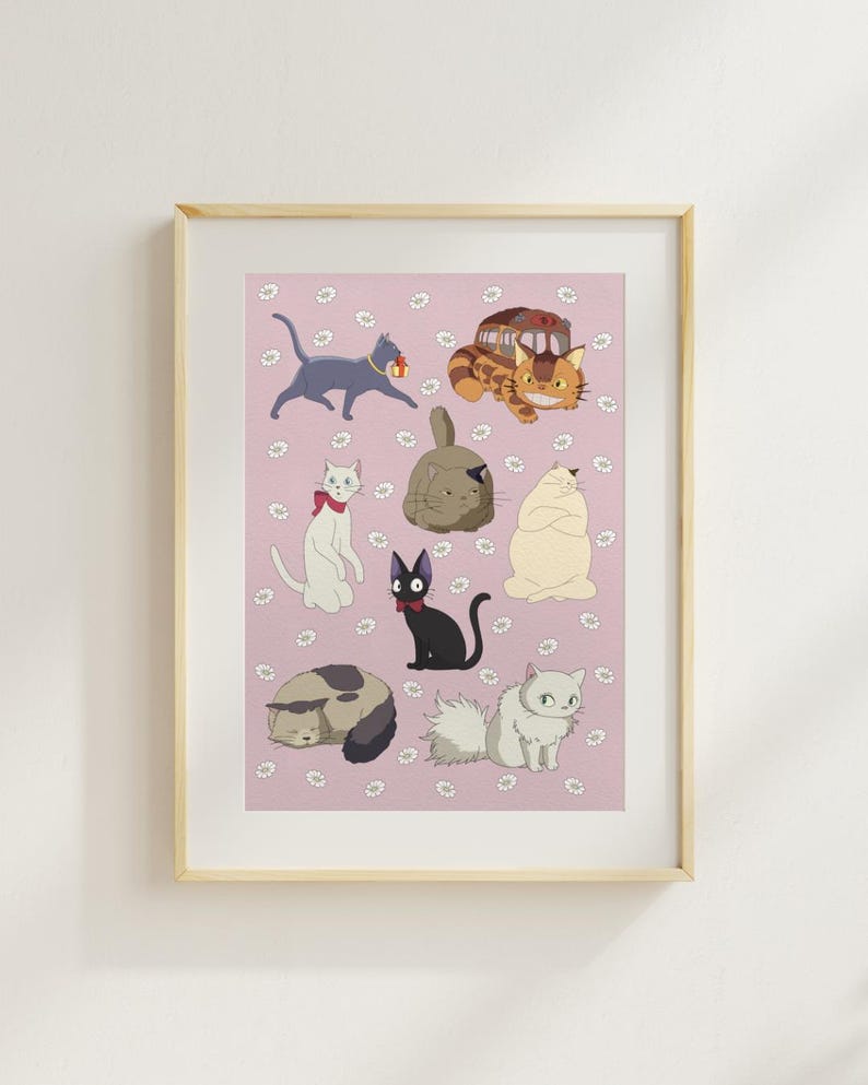 May include: A framed print featuring cartoon cats in various poses on a pink background with white flower accents. The cats are in different colors, including gray, black, white, and orange, and some have accessories like a bow tie.
