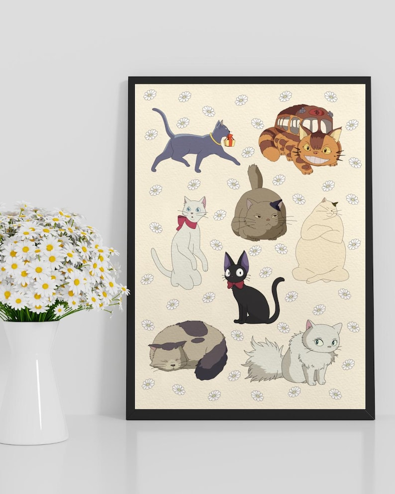 May include: A framed print featuring cartoon cats in various poses. The cats are in shades of gray, black, white, and orange, set against a cream background with small white flower patterns. The print is in a black frame.