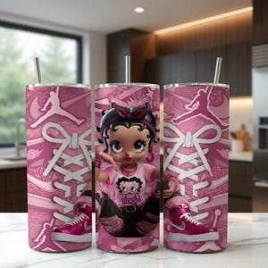 May include: Three pink insulated tumblers featuring a Betty Boop design, a pink and white sneaker design, and a Jumpman logo. Each tumbler has a silver straw and a pink and white sneaker design.