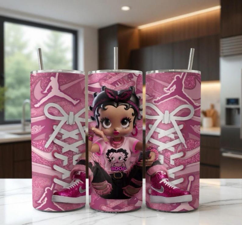 May include: Three pink insulated tumblers featuring a Betty Boop design, a pink and white sneaker design, and a Jumpman logo. Each tumbler has a silver straw and a pink and white sneaker design.