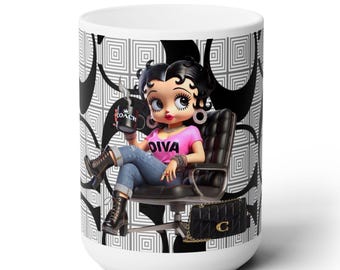 May include: White ceramic mug with a black and white geometric pattern. The mug features a cartoon image of a female character with black hair, wearing a pink shirt with the word "Diva" on it, blue jeans, and black boots. She is sitting in a black chair and holding a coffee cup with the word "Coach" on it. The mug also features a black purse with a gold "C" on it.