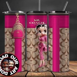 May include: A pink and brown tumbler with a design featuring the Coach logo and a cartoon image of Betty Boop. The tumbler has a black lid and a straw.