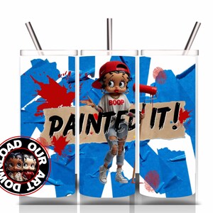 May include: A white tumbler with a Betty Boop design, featuring the text "PAINTED IT!" and a Betty Boop figure holding a paint roller. The design includes blue tape, red paint splatters, and a "DOWNLOAD OUR ART" logo.