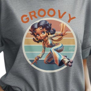 May include: Gray t-shirt featuring a cartoon illustration of a woman roller skating. The woman is wearing a colorful jumpsuit and roller skates, set against a retro sunset background. The word "GROOVY" is printed above the illustration.