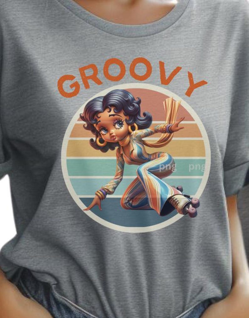 May include: Gray t-shirt featuring a cartoon illustration of a woman roller skating. The woman is wearing a colorful jumpsuit and roller skates, set against a retro sunset background. The word "GROOVY" is printed above the illustration.