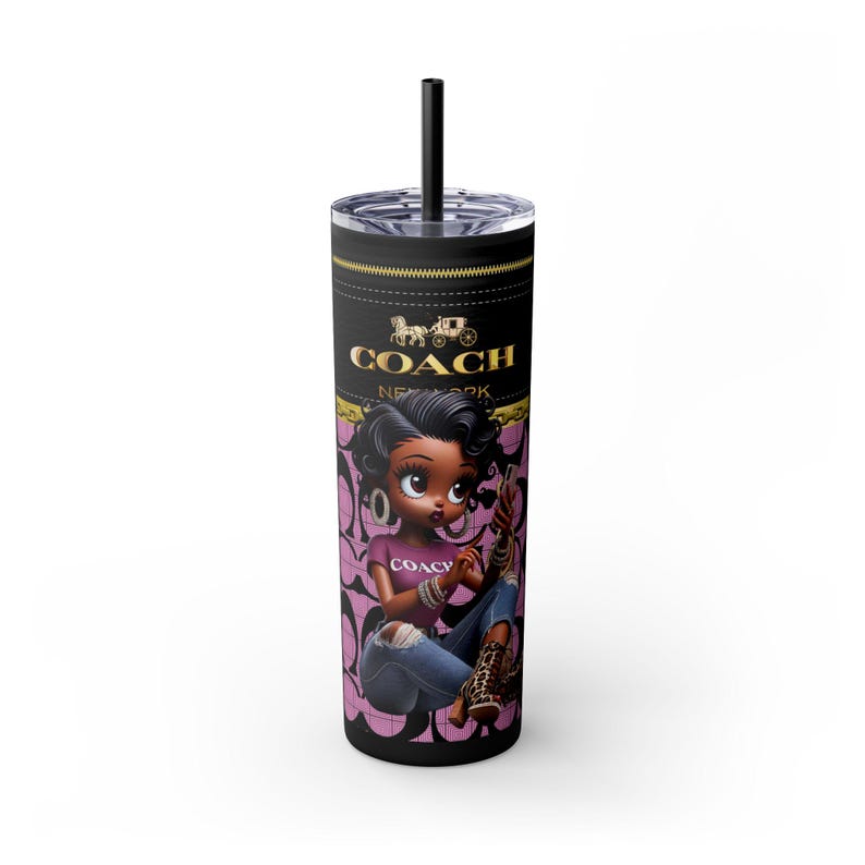 May include: A black and pink stainless steel tumbler with a cartoon illustration of a Black girl wearing a pink shirt with the word "Coach" on it, blue jeans, and a black boot. The tumbler has the words "Coach New York" in gold lettering.