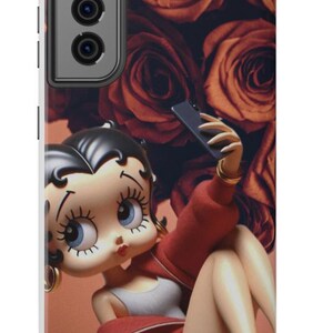 May include: A phone case featuring a cartoon character taking a selfie. The case has a red and orange color scheme with a background of roses. The character is wearing a red jacket and gray top.